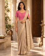 Rose pink front-hook saree blouse worn with a gold-bordered beige saree, standing indoors near ornate pillars