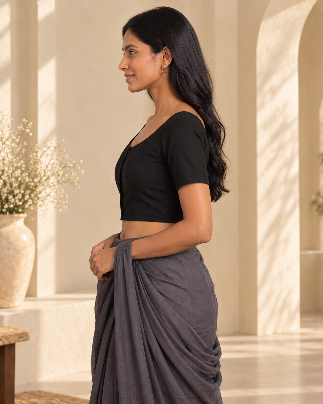 Classic black front-hook saree blouse in cotton, side profile view with grey saree draped over the shoulder